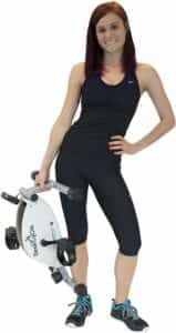 Femme qui porte le mini vélo d'intérieur à la main